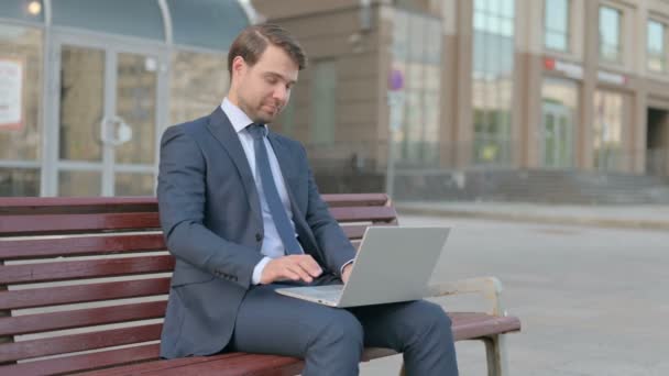 Young Businessman Laptop Showing Thumbs Sign While Sitting Outdoor Bench — Stockvideo