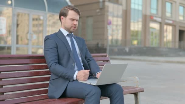 Thinking Middle Aged Businessman Using Laptop While Sitting Outdoor Bench — Stockvideo