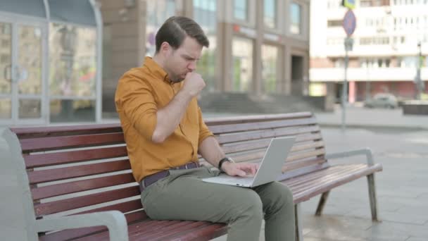 Coughing Casual Young Man Using Laptop While Sitting Outdoor Bench — Stockvideo