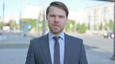 Portrait of Angry Middle Aged Businessman Fighting Outdoor
