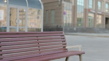 Young Businessman Coming, Sitting on Bench and Opening Laptop