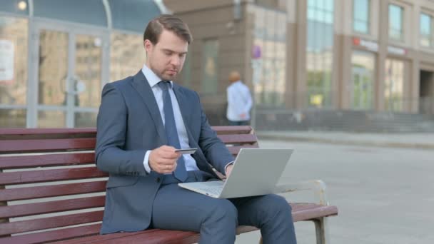 Young Businessman Reacting Online Payment Problem While Sitting Outdoor — Wideo stockowe