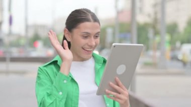 Video Call on Tablet by Young Woman Outdoor