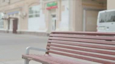 Young Woman Coming and Sitting on Bench Outdoor