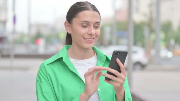 Young Woman Celebrating Online Success Smartphone Outdoor — Vídeo de Stock