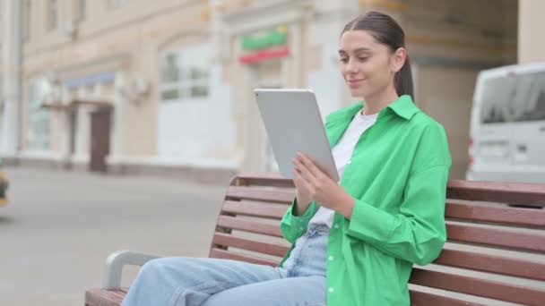Young Woman Using Tablet While Sitting Outdoor Bench — Stockvideo