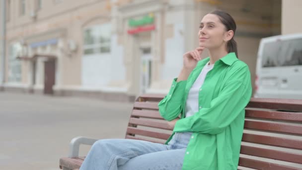 Pensive Young Woman Thinking While Sitting Outdoor Bench — Vídeo de Stock