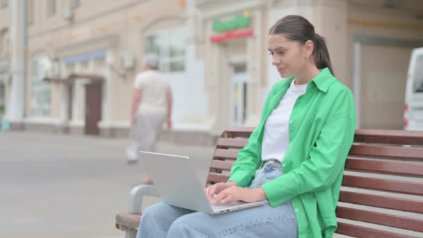 Young Woman Celebrating Success Laptop While Sitting Outdoor Bench — 비디오
