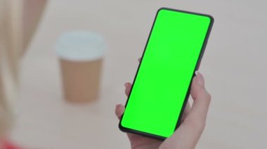 Close up of Young Woman Using Smartphone with Green Screen 