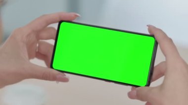 Close up of Young Woman Watching Smartphone with Chroma Screen 