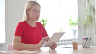 Young Woman Celebrating Online Win on Tablet