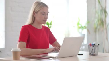 Young Woman showing Thumbs Up at Work