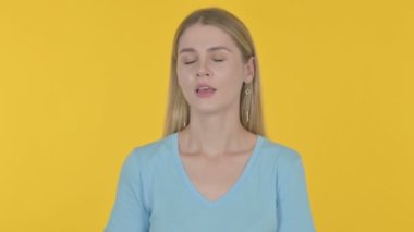 Tired Casual Young Woman Yawning on Yellow Background 