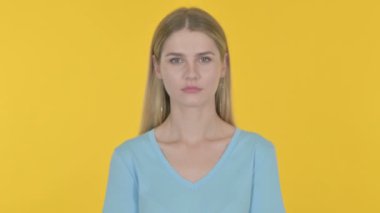Smiling Casual Young Woman on Yellow Background 