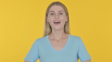 Successful Casual Young Woman Celebrating on Yellow Background 