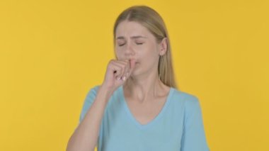 Casual Young Woman Coughing on Yellow Background 