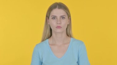 Shocked Casual Young Woman on Yellow Background 