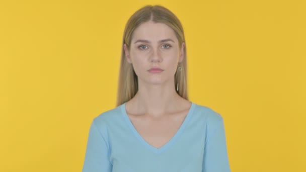 Serious Casual Young Woman Yellow Background — Stock Video