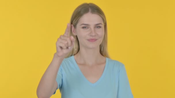 Casual Young Woman Pointing Camera Yellow Background — Stockvideo