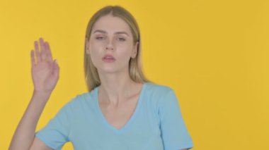 Casual Young Woman Trying to Listen Secret, Yellow Screen 