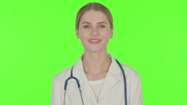 Smiling Young Female Doctor Green Background — Stock video