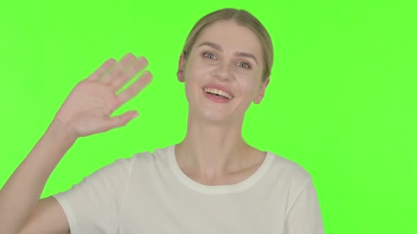 Casual Young Woman Waving Hand Say Hello Green Background — Video