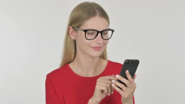 Casual Young Woman Browsing Smartphone White Background — Stockvideo