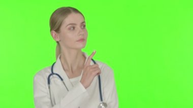 Young Female Doctor Pointing on Side on White Background 