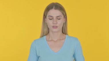 Casual Young Woman with Headache on Yellow Background 