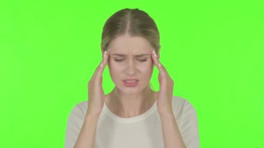 Casual Young Woman with Neck Pain on Green Background 