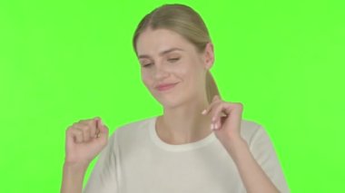 Casual Young Woman Feeling Scared, Frightened on Green Background
