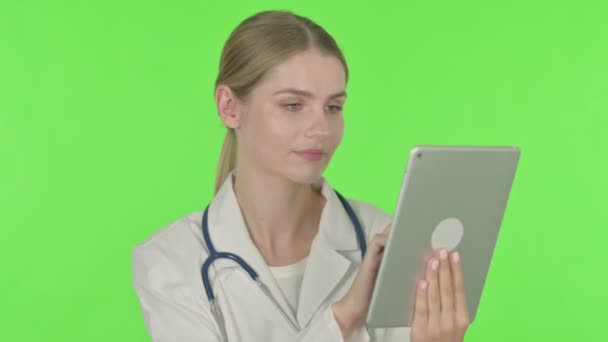 Young Female Doctor Using Digital Tablet Green Background — Stock video