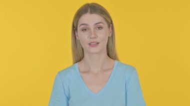 Casual Young Woman Talking on Online Video Call on Yellow Background 