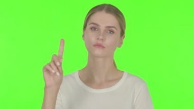 Casual Young Woman in Denial on Green Background 