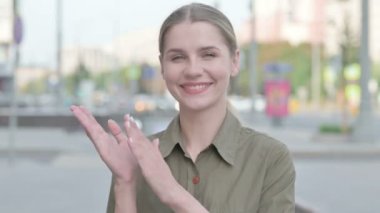 Young Woman Clapping in Appreciation Outdoor
