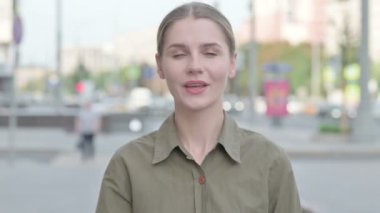 Flying Kiss by Loving Young Woman Outdoor