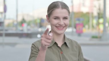 Young Woman Pointing at the Camera Outdoor