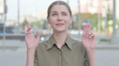 Young Woman Wishing for Good luck while Standing Outdoor