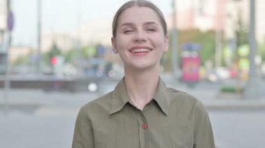 Positive Young Woman Shaking Head in Approval Outdoor