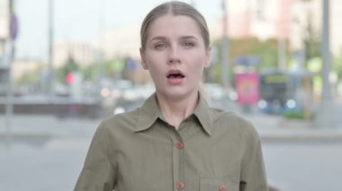 Portrait of Wondering Young Woman Shocked by Loss Outdoor