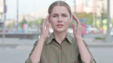 Distressed Young Woman with Headache Outdoor