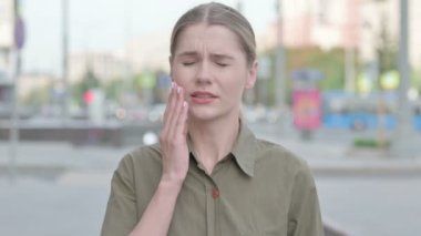 Discomforted Young Woman with Toothache Standing Outdoor