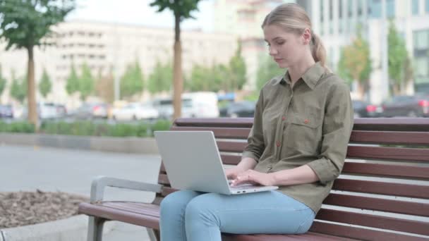 Young Woman Celebrating Success Laptop While Sitting Outdoor Bench — Vídeo de stock
