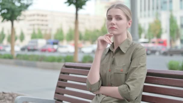 Pensive Young Woman Thinking While Sitting Outdoor Bench — Vídeo de Stock