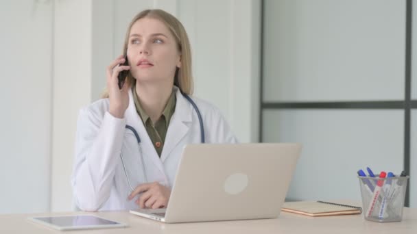 Lady Doctor Talking Phone While Working Laptop — Stock Video