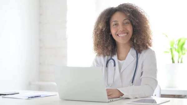 Young Afrcian Doctor with Laptop Shaking Head as Yes Sign