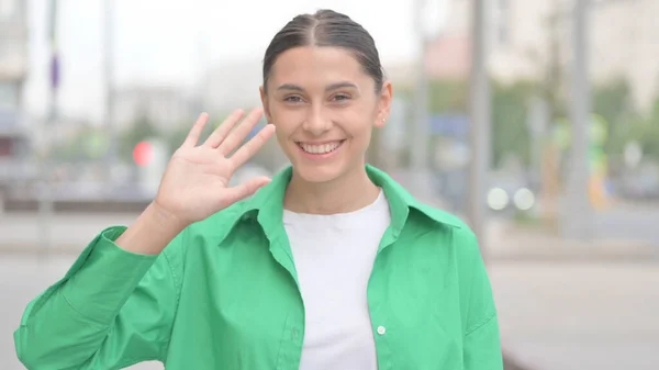 Welcoming Young Woman Waving Hand Hello Outdoor — ストック写真