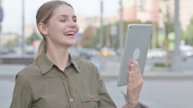 Video Call on Tablet by Young Woman Outdoor