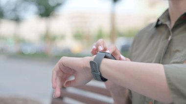 Close Up of Young Woman Using Smartwatch Outdoor