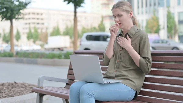 Coughing Young Woman Using Laptop While Sitting Outdoor Bench — ストック写真